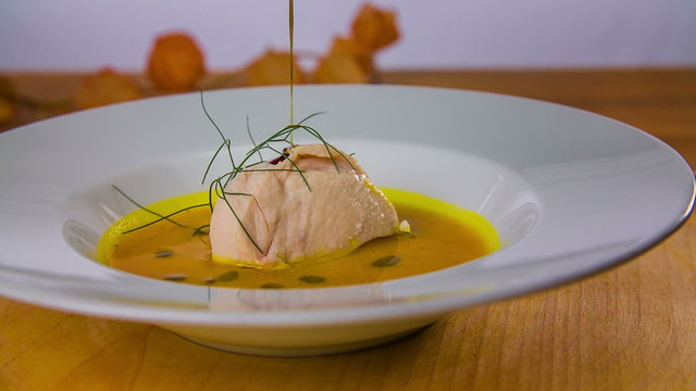 Drops of pumpkin oil on decorated food