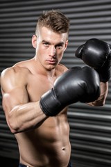 Shirtless man with boxing gloves