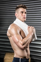 Obraz premium Shirtless man with towel around neck