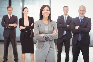 Businesspeople standing with arms crossed