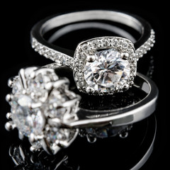 Luxury jewellery. White gold or silver engagement rings with diamonds closeup. Selective focus.