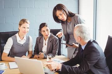 Businesspeople interacting in conference room