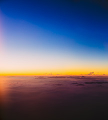 Beautiful colorful sunset over mountains from height of airplane