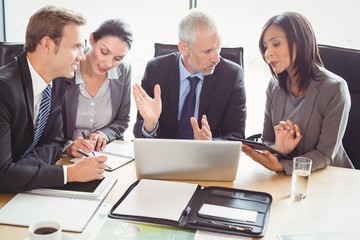 Businesspeople interacting in conference room