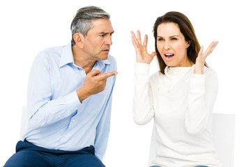 Couple arguing while sitting