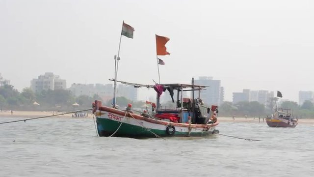 Sailing fishing boats in shallow water