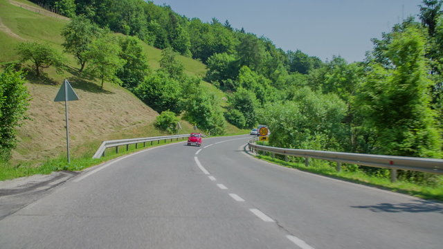 Small red zastava driving uphill