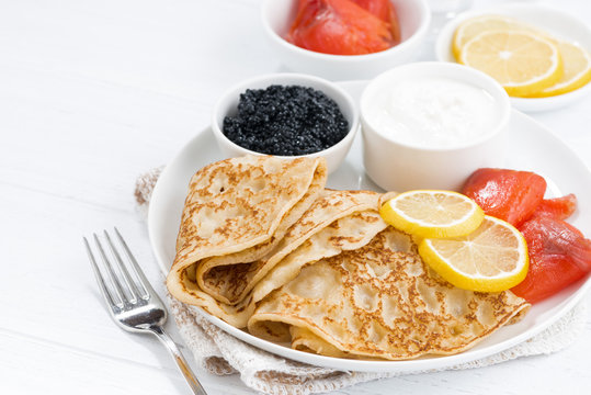 crepes with salted fish, sour cream and caviar, closeup