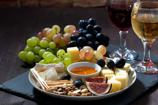 Plate with deli snacks and wine