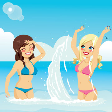 Two beautiful girls in bikini playing splattering water