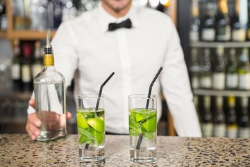 Bar tender making cocktails