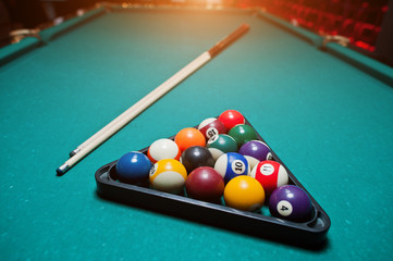 Billiard balls in a pool table at triangle with billiard cue