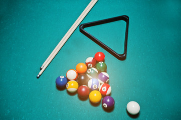 Billiard balls in a pool table at triangle with billiard cue