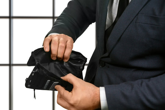 Office employee holding empty wallet.