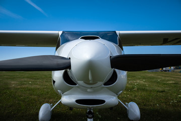 Front view of a small airplane close-up - 104997665