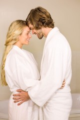 Cute couple embracing in bath robe