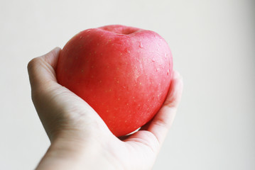 Red apple in a hand
