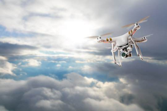 Drone for industrial works flying above clouds