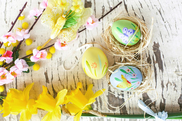 spring floral decoration and easter egg inside straw nest