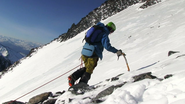 ALTAI , RUSSIA-MAY 2015: Iiktoo mountain, South Chui range, altitude 4000 m. Climber rises on a steep mountain snow slope. 
