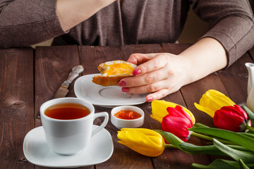 Woman eating bread with jam