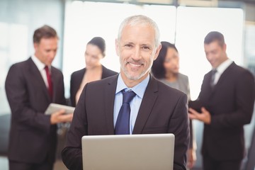 Businessman using laptop in office