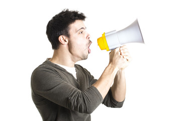 Young man shouting with megaphone on a white background