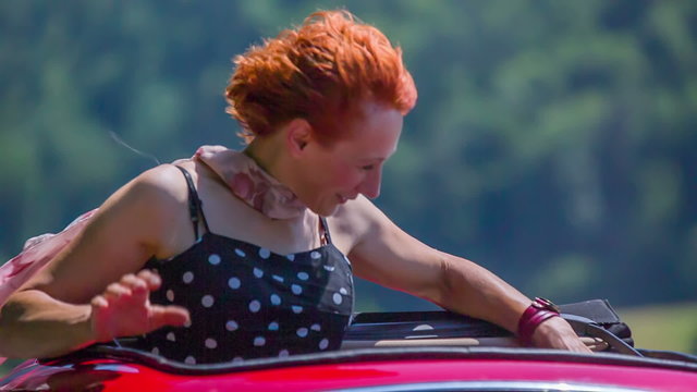 Older lady playing with her hair during a car ride