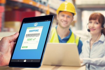Composite image of man using tablet pc 