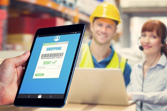 Composite image of man using tablet pc 