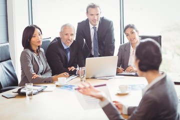 Businesspeople interacting in conference room