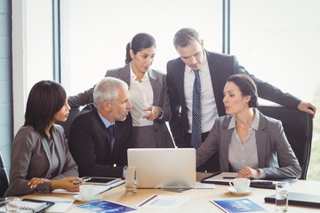 Businesspeople interacting in conference room