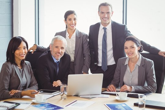Businesspeople smiling in conference room