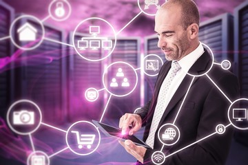 Composite image of businessman using a tablet 