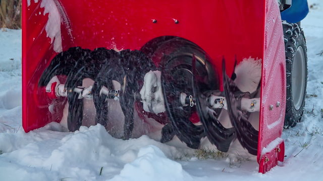 Spinning wheels on a snowblower