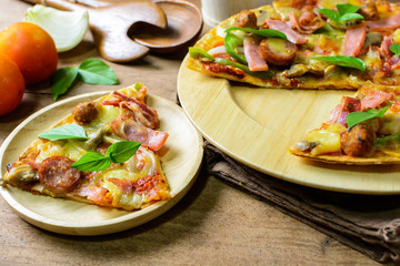 Rustic pizza with becon, salami, mozzarella and basil