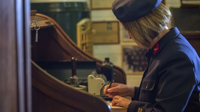 Woman sitting at work table in the train station museum