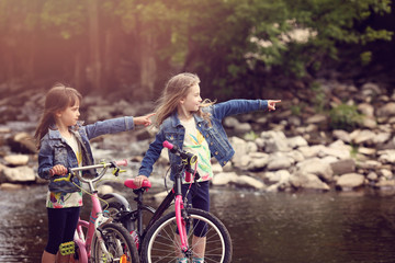 Two young girls on a bike trip