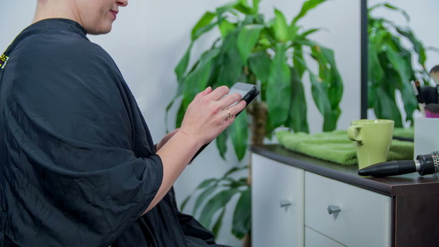 At hair dresser browse on smart pad at hair styler 