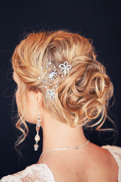 beautiful hairdress of the bride on a black background