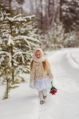 Fototapeta na wymiar Russian girl in the winter woods with a bouquet of flowers 
