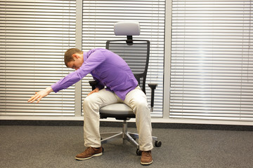 man exercising on chair in office, healthy lifestyle 