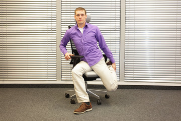 man exercising on chair in office, healthy lifestyle