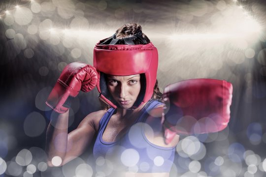 Composite image of portrait of female boxer with gloves