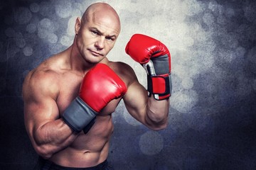 Composite image of portrait of boxer with red gloves