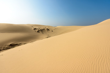 Fototapeta na wymiar White sands Dunes in Vietnam, White desert background,Popular tourist attractions in South of Vietnam.