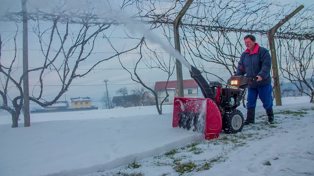 Using a snowblower on a winter day