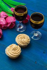 two glasses of red wine and tulips