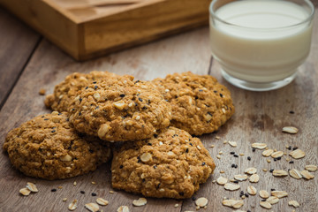 Oatmeal cookies with sesame seeds and glass of milk