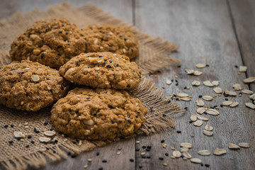 Oatmeal cookies with sesame seeds on sackcloth